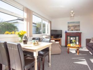 a living room with a table and a fireplace at 310 The Cove - Ukc5025 in Dawlish