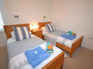 a bedroom with two beds and a night stand with twounks at The Sanctuary in Sandown