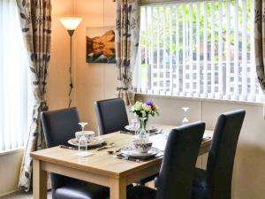 a dining room with a table and chairs and a window at Bluebell Lodge - Ukc5526 in West Thirston