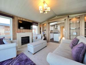 a living room with a couch and a fireplace at Knightsbridge 30 in Cameron