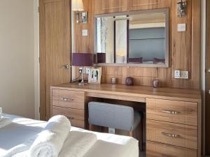 a bedroom with a desk and a mirror at Knightsbridge 30 in Cameron +3 photos