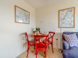 a dining room with a red table and chairs at Little Scarlett - Ukc6132 in Eastdean