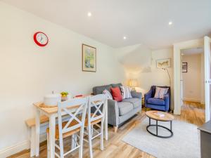 a living room with a couch and a table at White Cottage - Ukc6133 in Eastdean