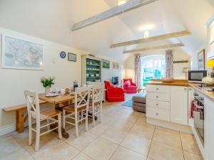 a kitchen and dining room with a table and chairs at Thyme Cottage - Ukc6131 in Eastdean +18 photos