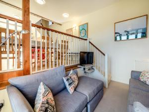 a living room with a couch and a tv at Beachy Barn - Ukc6126 in Eastdean