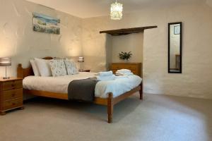 a bedroom with a bed with two towels on it at Towan Cottage - Cwc79064 in Perranporth