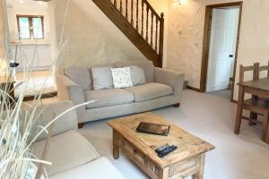 a living room with a couch and a coffee table at Towan Cottage - Cwc79064 in Perranporth