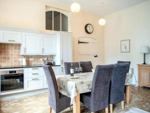 a dining room with a table and chairs and a kitchen at The Amherst House in Bury Saint Edmunds +14 photos