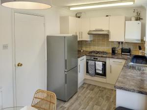 a kitchen with a stainless steel refrigerator at Redcot Gardens in Stamford