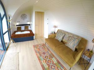 a living room with a couch and a bed at Oak Tree Retreat in Dronfield