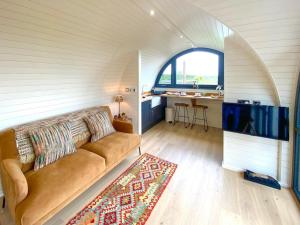 a living room with a couch and a tv at Oak Tree Retreat in Dronfield