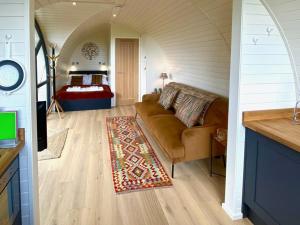 a living room with a couch and a bedroom at Oak Tree Retreat in Dronfield