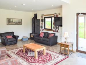 a living room with a couch and a table at The Farmhouse - Ukc6250 in Linlithgow