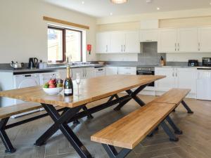 a kitchen with a wooden table with a bowl of fruit at The Farmhouse - Ukc6250 in Linlithgow +14 photos