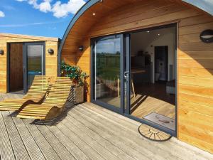 a wooden deck with two chairs on a house at Meikle Balloch - Ukc6069 in Newmill +2 photos