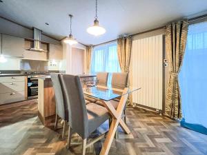 a kitchen with a table and chairs in a room at Saltire 26 in St. Andrews