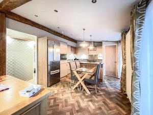 a kitchen with a wooden floor and a table at Saltire 26 in St. Andrews