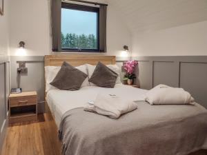 a bedroom with a large bed with two pillows on it at Ben Rinnes - Ukc6028 in Newmill