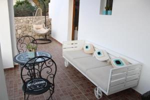 a hospital bed with a table and a table and chairs at SunΚissed Suite - Pollonia Milos in Pollonia
