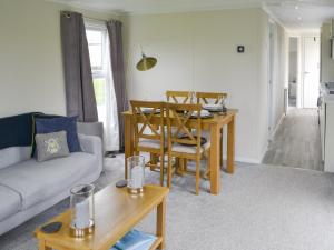 a living room with a couch and a table at Unwind 37 - Uk43980 in West Thirston