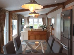 a kitchen and living room with a table and a refrigerator at Rivendale 76 in St. Andrews