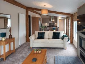 a living room with a couch and a table at Rivendale 76 in St. Andrews