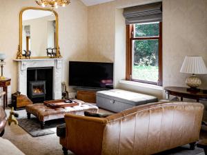a living room with a couch and a fireplace at The Servant's Hall - Ukc6964 in Carnoustie
