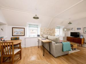 a living room with a couch and a table at Fishermans's Rest in Lossiemouth
