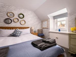a bedroom with a bed and mirrors on the wall at Fishermans's Rest in Lossiemouth +7 photos
