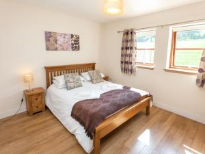 a bedroom with a bed and a window at Beech Cottage - Ukc6252 in Linlithgow +7 photos