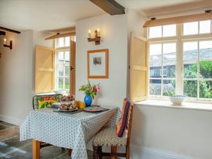 a dining room with a table and a window at The North Wing - Ukc6794 in Saint Gennys