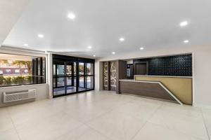an empty room with a lobby with large windows at Baymont by Wyndham Arlington At Six Flags Dr in Arlington +53 photos