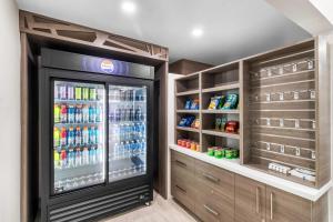 a drink refrigerator in a room with lots of drinks at Baymont by Wyndham Arlington At Six Flags Dr in Arlington