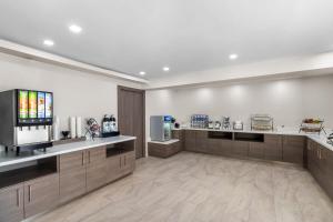 a large room with a cashierasteryasteryasteryasteryasteryasteryasteryasteryastery at Baymont by Wyndham Arlington At Six Flags Dr in Arlington