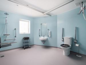 a blue bathroom with a toilet and a sink at Emsdorf Lodge - Ukc5800 in Lundin Links