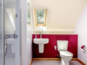 a bathroom with a white toilet and a sink at Emsdorf Lodge - Ukc5800 in Lundin Links +2 photos