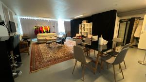 a living room with a dining room table and chairs at Whaletours Center Apartment in Ilulissat