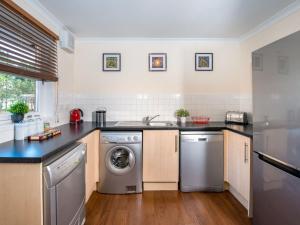 a kitchen with a sink and a dishwasher at The Cairngorm - Ukc5051 in Aviemore