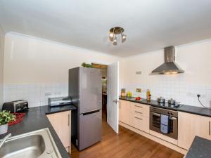 a kitchen with a stainless steel refrigerator and a sink at The Cairngorm - Ukc5051 in Aviemore