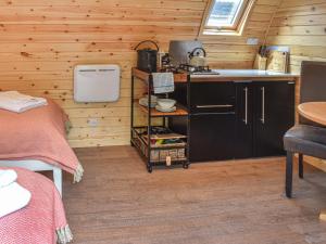 a kitchen with a sink and a stove in a room at Hornbeam - Uk44262 in Waldron