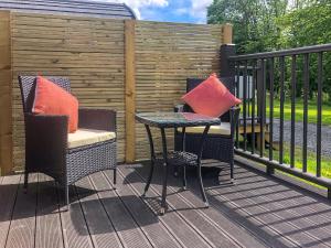 two chairs and a table on a deck at Hornbeam - Uk44262 in Waldron +2 photos