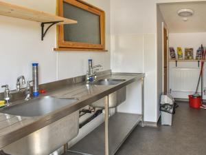 a kitchen with two sinks and a counter at Hornbeam - Uk44262 in Waldron