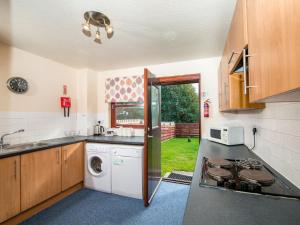 a kitchen with a sink and a stove top oven at Munro View - Ukc5040 in Aviemore