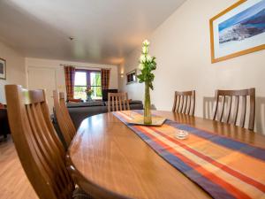 a dining room with a wooden table and chairs at Munro View - Ukc5040 in Aviemore