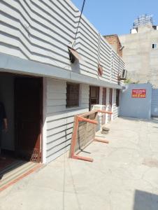 a white building with a black and white roof at Thakur Shri Dwarkadhish Seva Sadan in Mathura