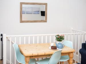 a wooden table and chairs with a vase on it at Number Seven - Ukc4969 in Tawstock
