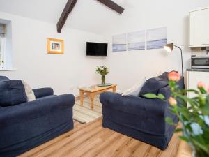 a living room with two blue couches and a table at Number Seven - Ukc4969 in Tawstock +22 photos