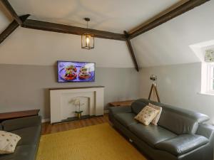 a living room with a couch and a fireplace at Number One - Ukc4963 in Tawstock