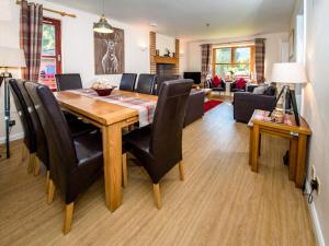 a dining room and living room with a table and chairs at The Stag-Ukc5066 in Aviemore