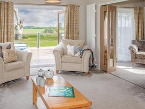 a living room with two chairs and a coffee table at Rivendale in St. Andrews